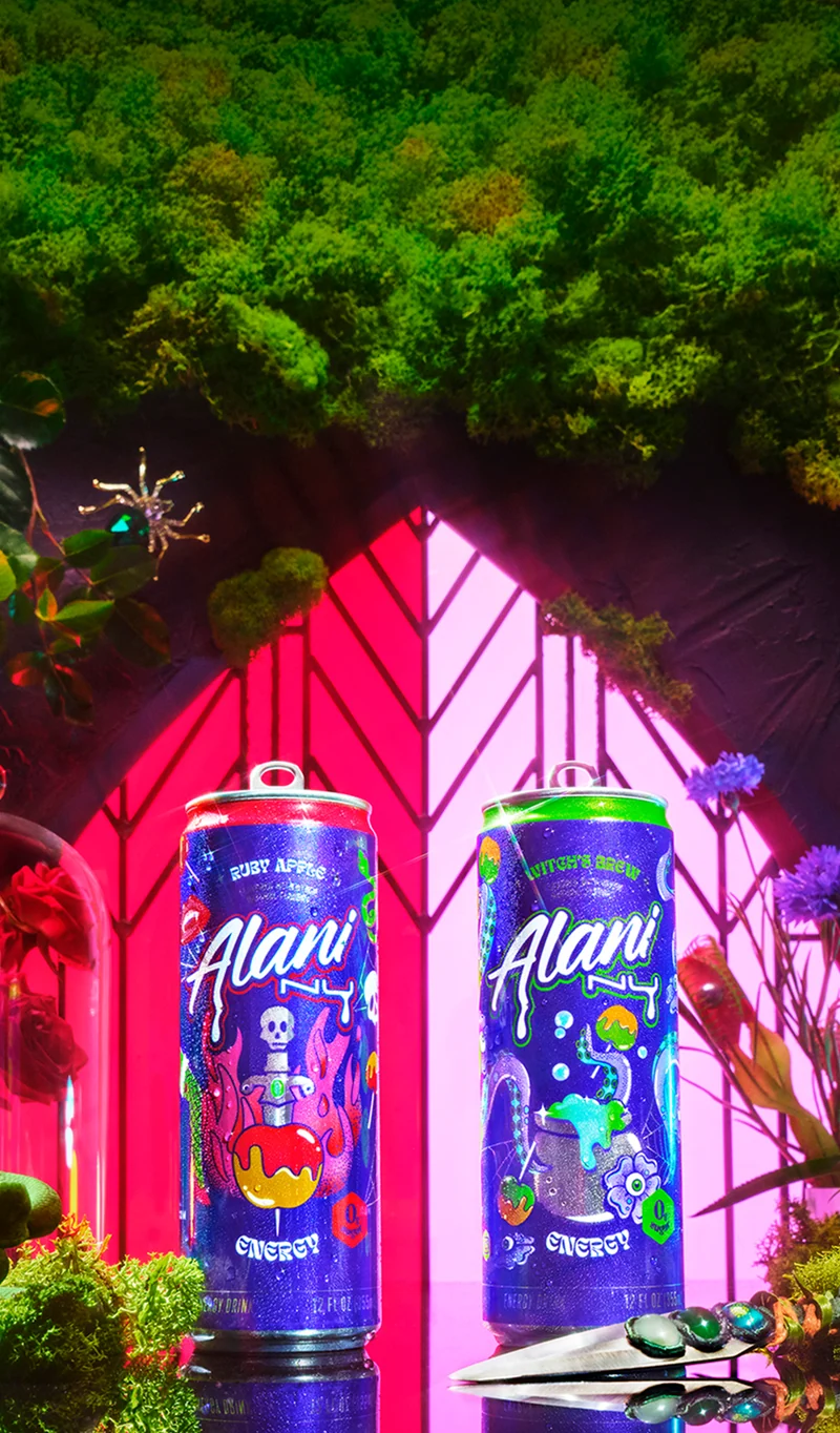 Three colorful energy drink cans are displayed with an orange and peach, against a vibrant pink and orange gradient background.